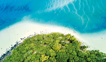 An aerial view of an island in the middle of the ocean